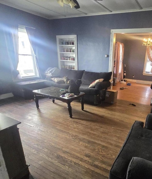 207 Broad Ave, Susquehanna, PA 18847 - living room with wood finished floors, built in shelves, and crown molding
