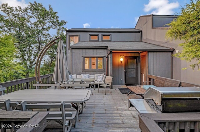 rear view of house with a wooden deck and an outdoor hangout area