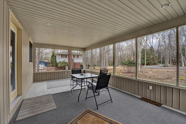 sunroom featuring outdoor dining space