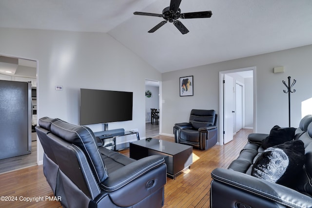 living area featuring vaulted ceiling, ceiling fan, and hardwood / wood-style floors