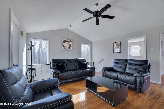 living area featuring vaulted ceiling, wood-type flooring, and a wealth of natural light