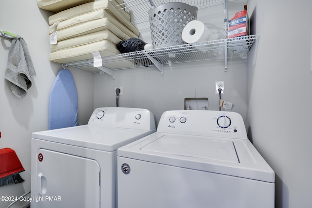 clothes washing area featuring laundry area and washer and clothes dryer