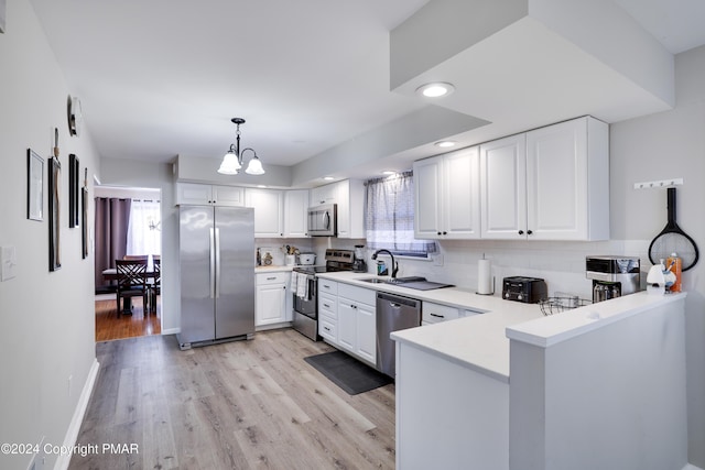 kitchen with stainless steel appliances, backsplash, a sink, and a healthy amount of sunlight