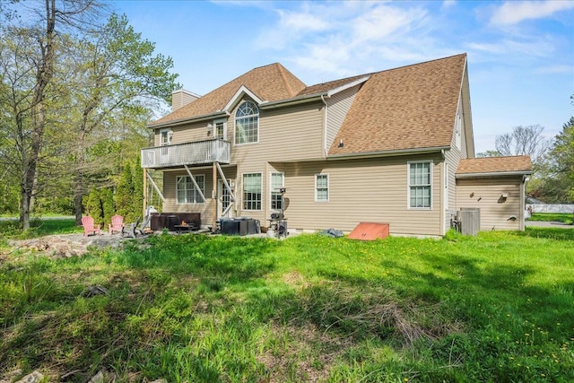 392 Hemlock Dr, Tobyhanna, PA 18466 - back of house with a chimney, a deck, central air condition unit, and a shingled roof