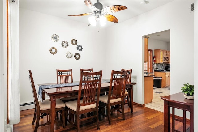 392 Hemlock Dr, Tobyhanna, PA 18466 - dining area featuring a ceiling fan, light wood finished floors, and a baseboard radiator