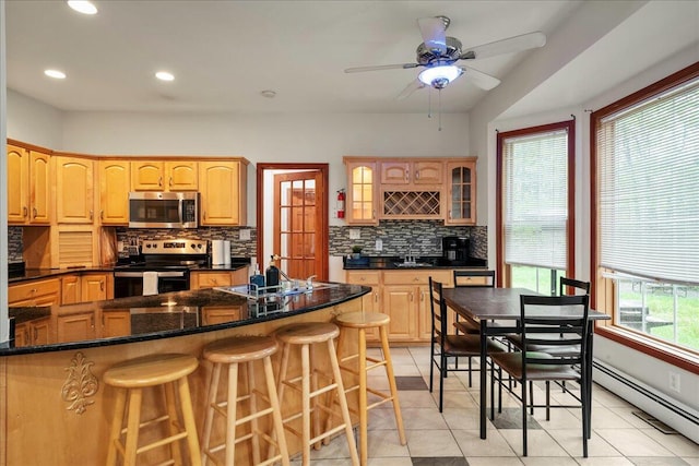 392 Hemlock Dr, Tobyhanna, PA 18466 - kitchen with stainless steel appliances, a sink, a baseboard heating unit, backsplash, and recessed lighting