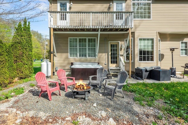 392 Hemlock Dr, Tobyhanna, PA 18466 - rear view of house with an outdoor fire pit, a hot tub, a patio area, and a wooden deck