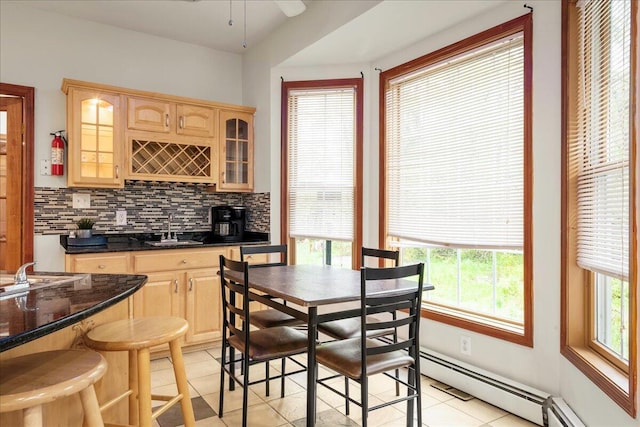 392 Hemlock Dr, Tobyhanna, PA 18466 - kitchen featuring a sink, light brown cabinetry, light tile patterned floors, backsplash, and glass insert cabinets