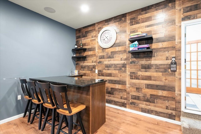 392 Hemlock Dr, Tobyhanna, PA 18466 - indoor wet bar featuring wooden walls, baseboards, and light wood-type flooring