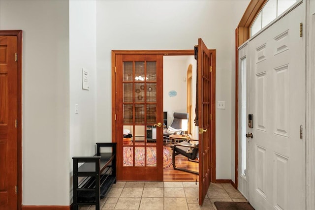 392 Hemlock Dr, Tobyhanna, PA 18466 - entryway featuring light tile patterned flooring, arched walkways, and baseboards