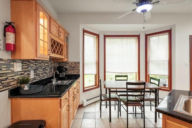 392 Hemlock Dr, Tobyhanna, PA 18466 - kitchen with tasteful backsplash, a baseboard radiator, a sink, a ceiling fan, and healthy amount of natural light