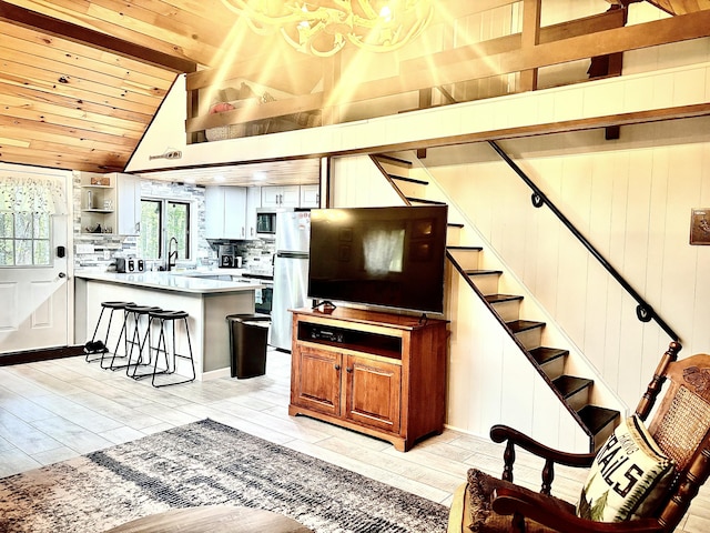 256 Partridge Dr, Pocono Lake, PA 18347 - living area with vaulted ceiling, stairs, wooden ceiling, light wood-style floors, and a chandelier