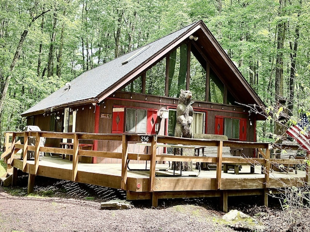 256 Partridge Dr, Pocono Lake, PA 18347 - rear view of house featuring a forest view, a shingled roof, and a wooden deck