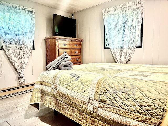 256 Partridge Dr, Pocono Lake, PA 18347 - bedroom with hardwood / wood-style floors, baseboard heating, and a decorative wall