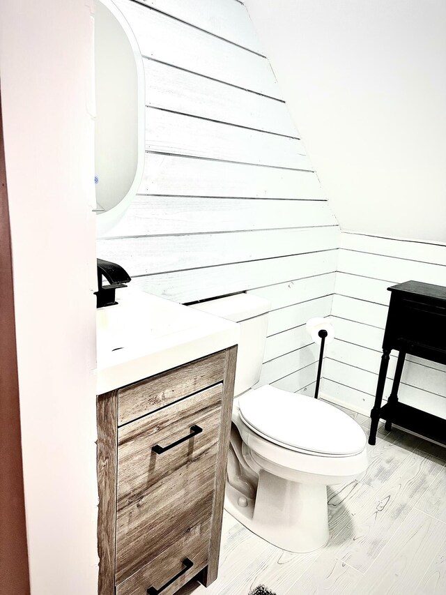 256 Partridge Dr, Pocono Lake, PA 18347 - bathroom featuring vanity, toilet, and wood walls