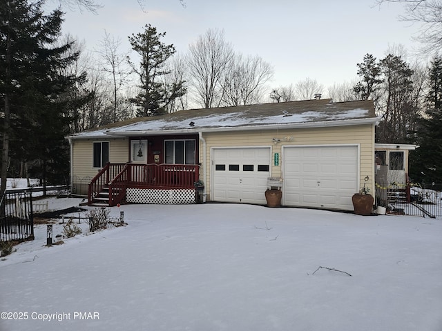 view of front of home with an attached garage and fence