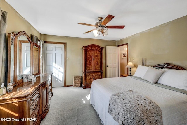 bedroom with ceiling fan and light colored carpet