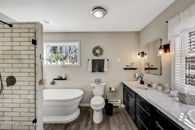 full bathroom with hardwood / wood-style flooring, toilet, baseboard heating, plus walk in shower, and vanity