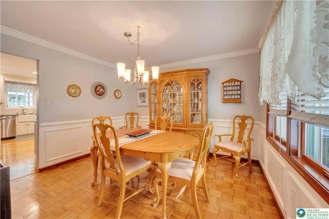 536 Mcilhaney Rd, Stroudsburg, PA 18360 - dining space with a chandelier, a decorative wall, crown molding, and wainscoting