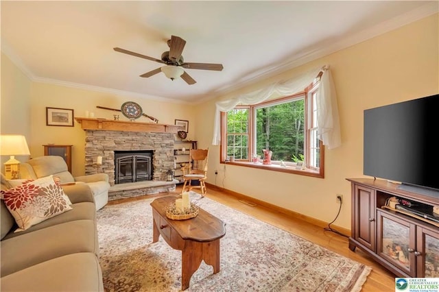536 Mcilhaney Rd, Stroudsburg, PA 18360 - living room featuring ceiling fan, ornamental molding, a fireplace, and light wood finished floors