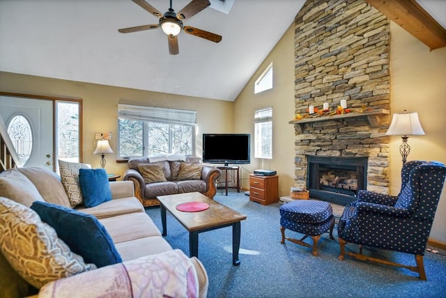 carpeted living room featuring a fireplace, beam ceiling, a ceiling fan, and high vaulted ceiling
