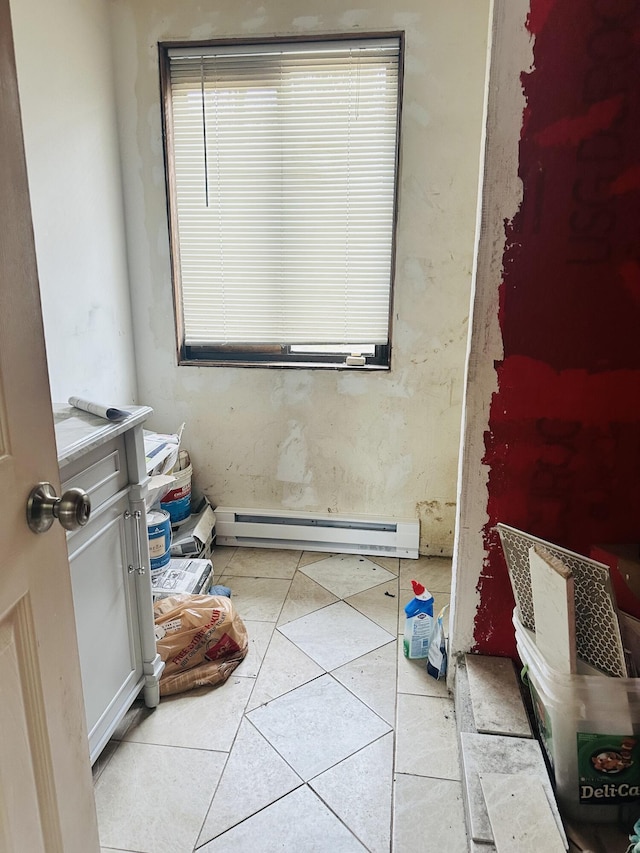 bathroom with tile patterned flooring and baseboard heating