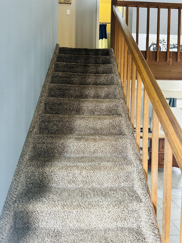 stairs with tile patterned flooring