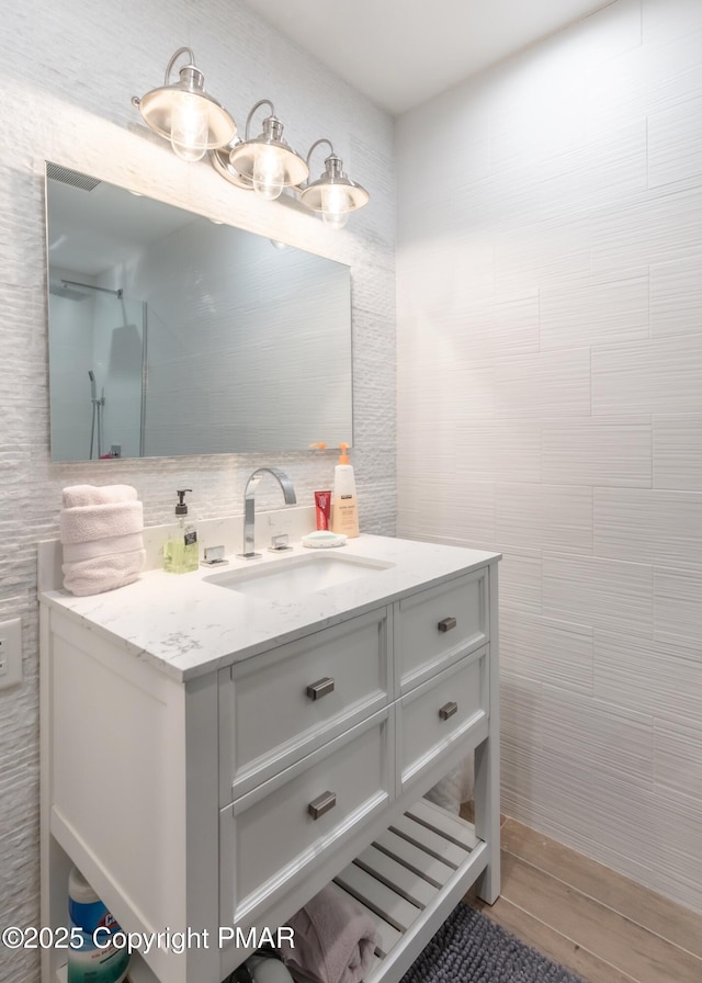 bathroom featuring tile walls and vanity