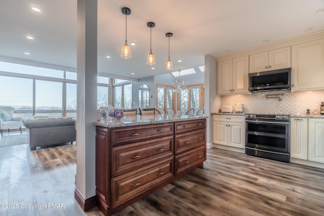 kitchen featuring decorative backsplash, appliances with stainless steel finishes, dark wood-style flooring, and light stone countertops