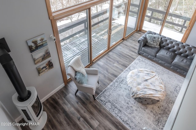 living area with plenty of natural light, baseboards, and wood finished floors