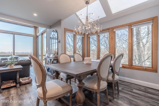 dining area with dark wood-type flooring and an inviting chandelier