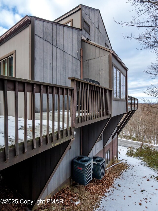 view of snowy exterior with central air condition unit