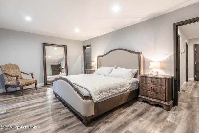 bedroom with light wood-style flooring, recessed lighting, and baseboards