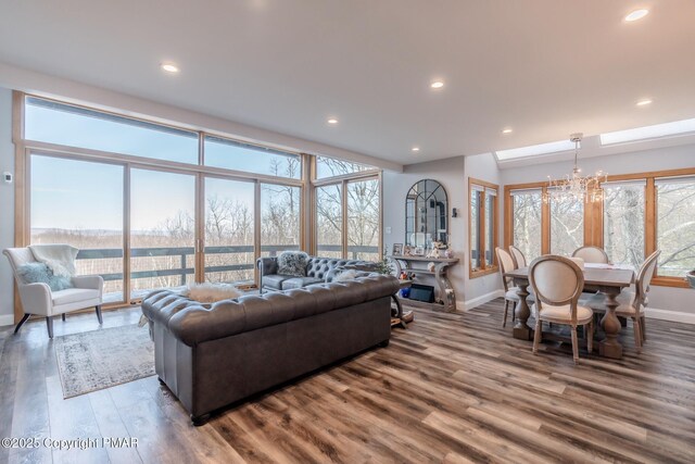 living room with a notable chandelier and wood-type flooring