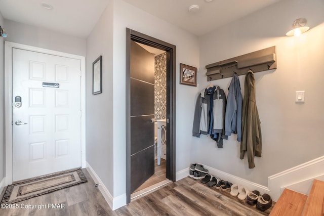 interior space featuring baseboards and wood finished floors