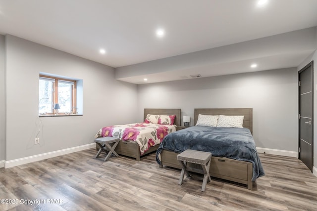 bedroom featuring visible vents, recessed lighting, wood finished floors, and baseboards