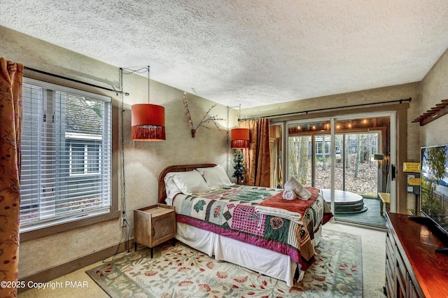 bedroom with access to outside and a textured ceiling