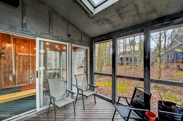 sunroom / solarium with lofted ceiling with skylight