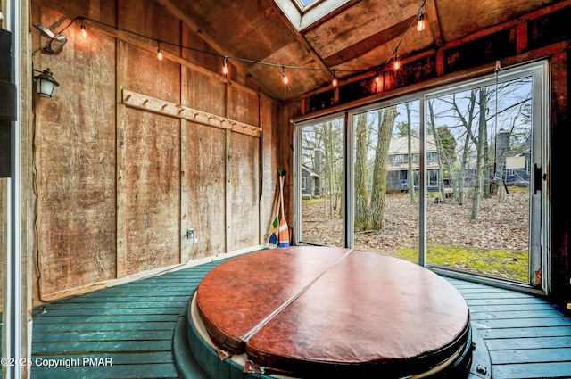 sunroom with lofted ceiling with skylight