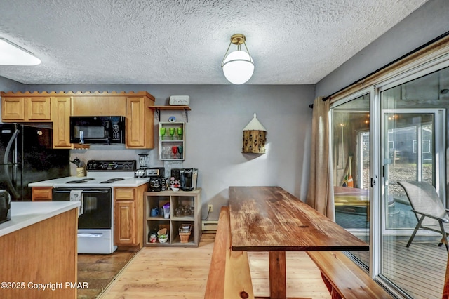 kitchen with light wood finished floors, a baseboard radiator, light countertops, black appliances, and open shelves