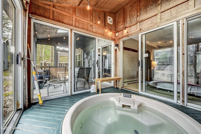 sunroom featuring a hot tub