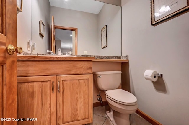 bathroom with vanity, tile patterned flooring, toilet, and baseboards