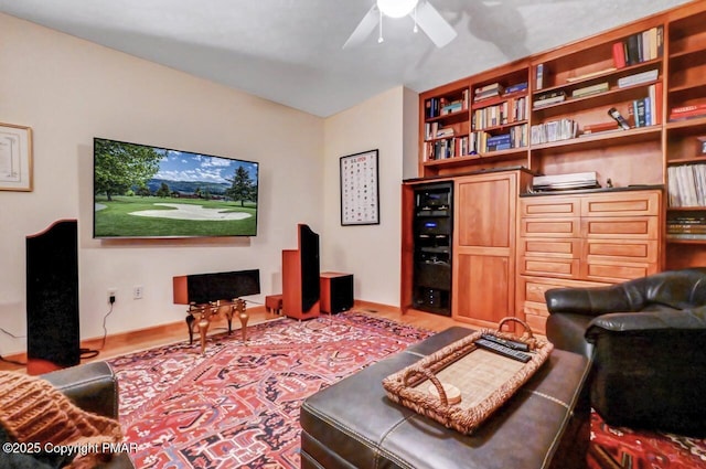 living area featuring a ceiling fan and wood finished floors