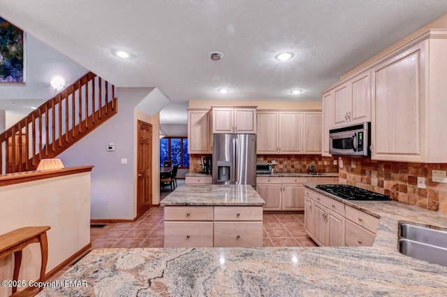 kitchen with tasteful backsplash, baseboards, light tile patterned flooring, stainless steel appliances, and recessed lighting