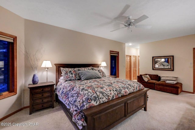 bedroom with light carpet, ceiling fan, and baseboards