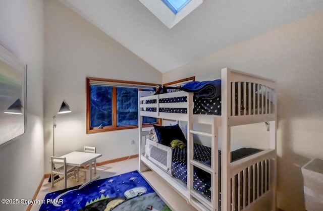 bedroom featuring lofted ceiling and baseboards