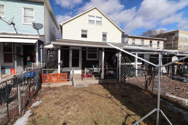 rear view of house featuring fence