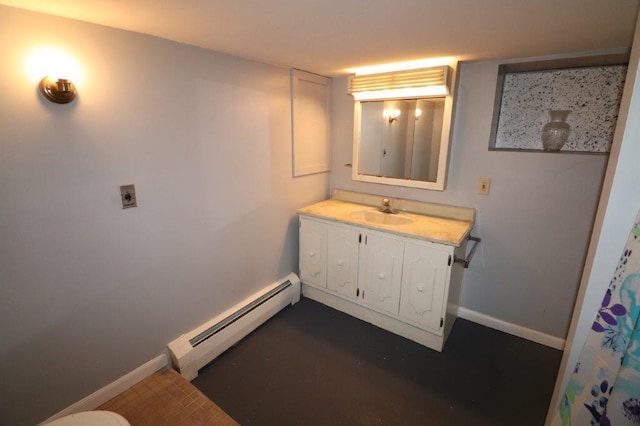 bathroom with a baseboard heating unit, vanity, and baseboards