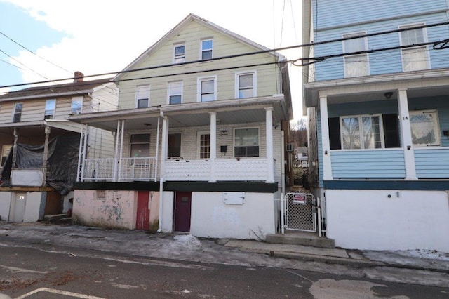 view of front of property featuring a porch and a gate