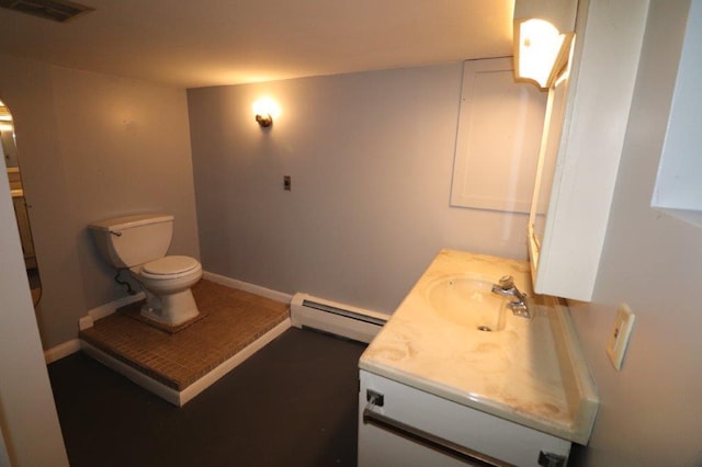 half bath with visible vents, toilet, a baseboard heating unit, vanity, and baseboards